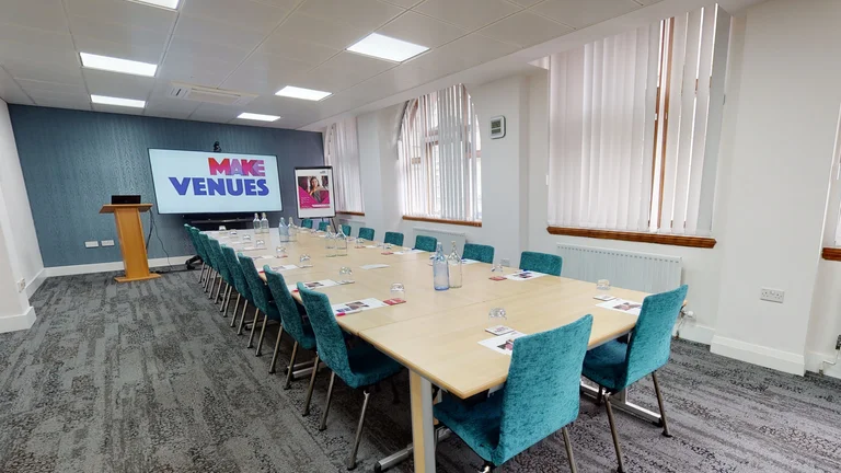 Medium Meeting room set up with screen and lectern for presenting