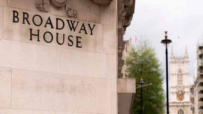 Broadway House Sign on stone wall outside 