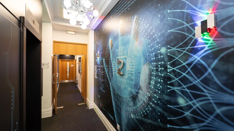 Corridor in Broadway House with large 2 on the wall that features a technology-inspired design