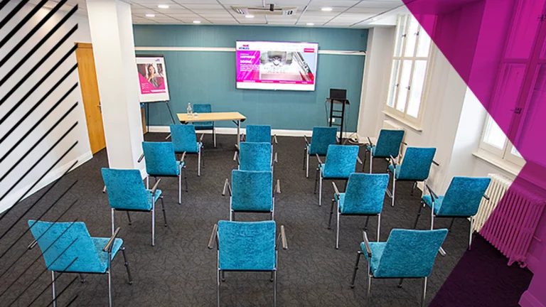 Small seminar room with chairs facing an interactive board.