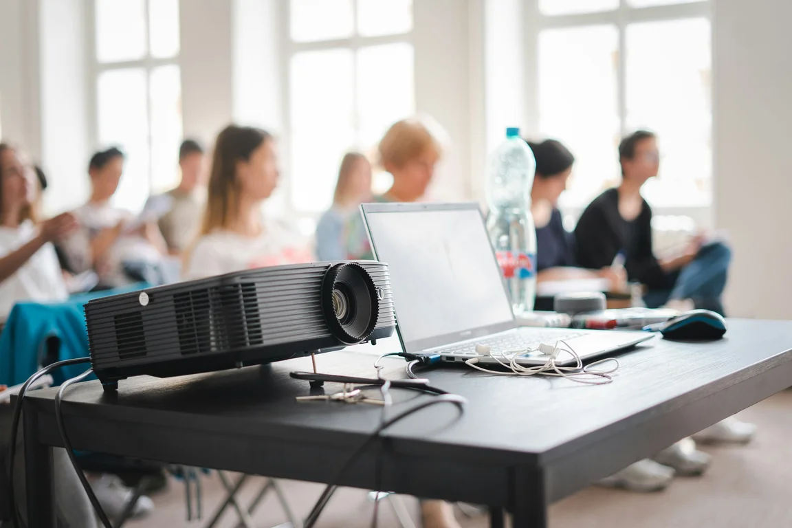projector and laptop on table at a conference event